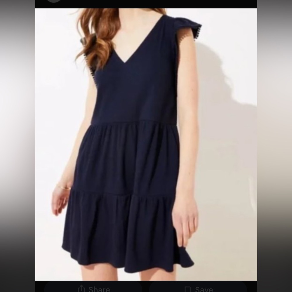 navy blue LOFT lacy tier flutter dress with pom-pom details on the sleeves.